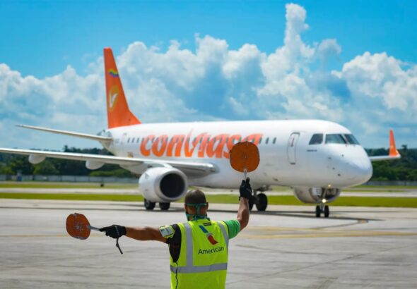 Ground staff directs a Conviasa plane at Simón Bolívar International Airport, Venezuela. File photo.