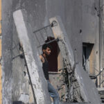 A Palestinian man walks on building rubble following Israeli strikes on the Rafah refugee camp in the southern Gaza Strip on October 25, 2023. Photo: AFP.