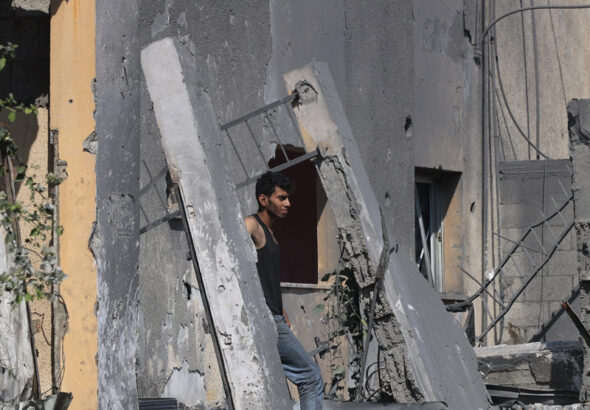A Palestinian man walks on building rubble following Israeli strikes on the Rafah refugee camp in the southern Gaza Strip on October 25, 2023. Photo: AFP.