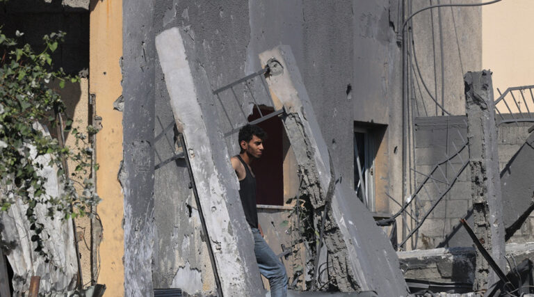 A Palestinian man walks on building rubble following Israeli strikes on the Rafah refugee camp in the southern Gaza Strip on October 25, 2023. Photo: AFP.