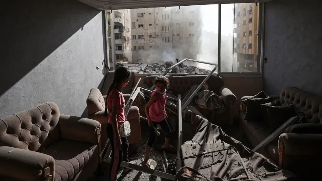 Palestinian children in a bombed building in Gaza. Photo: Mustafa Hassona/Anadolu Agency/Getty Images.