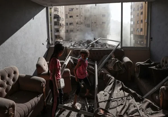 Palestinian children in a bombed building in Gaza. Photo: Mustafa Hassona/Anadolu Agency/Getty Images.