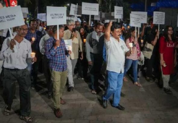 Journalists take part in a candle march against Police raid on news portal NewsClick, in Mumbai on Thursday. Photo: PTI.