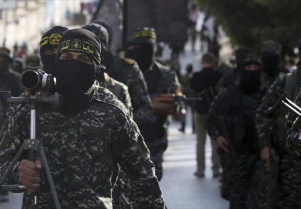 Members of the Al-Quds Brigades, the military wing of the Palestinian Resistance, march with their weapons to show loyalty to the new elected leader al-Nakhalah, during a rally in Gaza, October 4 2018. Photo: Adel Hana/AP/File photo.