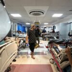 Men walk as patients rest at Al-Shifa hospital in Gaza City on November 10, 2023. Photo: AFP.