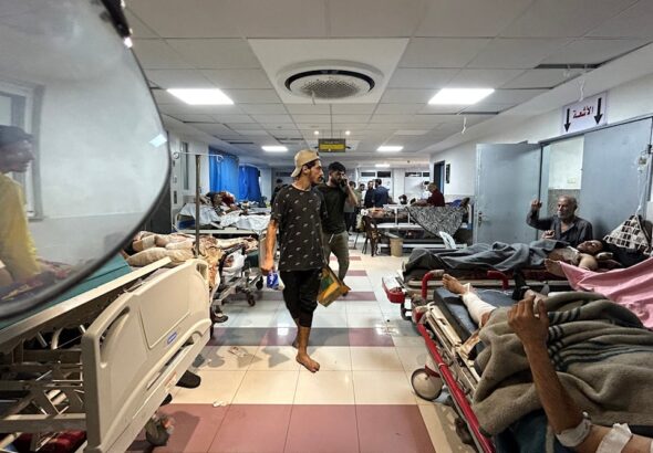 Men walk as patients rest at Al-Shifa hospital in Gaza City on November 10, 2023. Photo: AFP.