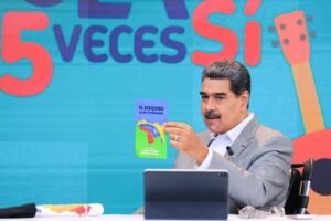 Venezuelan President Nicolás Maduro holds a pamphlet which reads "El Esequibo es de Venezuela," meaning "The Essequibo is Venezuela's."