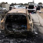 Burnt cars are abandoned in a carpark near where a music festival was held before an attack by Hamas gunmen from Gaza, in southern Israel, October 10. Photo: REUTERS/Ronen Zvulun.