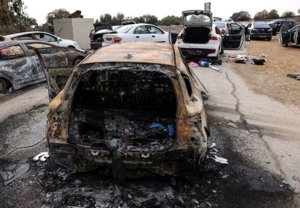 Burnt cars are abandoned in a carpark near where a music festival was held before an attack by Hamas gunmen from Gaza, in southern Israel, October 10. Photo: REUTERS/Ronen Zvulun.