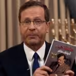 The president of the Israeli settler entity, Isaac Herzog, showing a copy of Hitler’s Main Kampf book in Arabic allegedly found in a raided house, in a pathetic attempt to justify the genocide his government is conducting against Palestinians in Gaza. Photo: BBC/File photo.