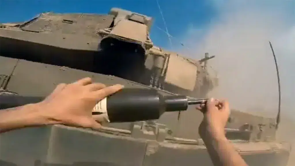 Resistance fighter placing a bomb on an Israeli Merkava tank. Photo: Palestinian Resistance footage.