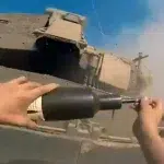 Resistance fighter placing a bomb on an Israeli Merkava tank. Photo: Palestinian Resistance footage.