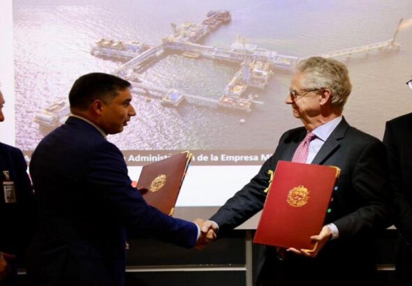 Venezuelan Oil Minister Pedro Tellechea (left) and Maurel & Prom Iberoamérica President Olivier de Langavant (right) shake hands after the signing of an oil production agreement between PDVSA and the French company. Photo: Instagram/@pequivensa.