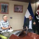 Finance Minister Ivan Acosta (right) tells John Perry that Nicaragua has an excellent reputation globally for completing projects and accounting for the money it receives. Photo: Consortium News.