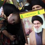 Hezbollah supporters hold a picture of Hezbollah Secretary General Sayyed Hassan Nasrallah on November 3rd 2023. Photo: Haitham al-Mousawi/Al-Akhbar.