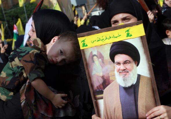 Hezbollah supporters hold a picture of Hezbollah Secretary General Sayyed Hassan Nasrallah on November 3rd 2023. Photo: Haitham al-Mousawi/Al-Akhbar.