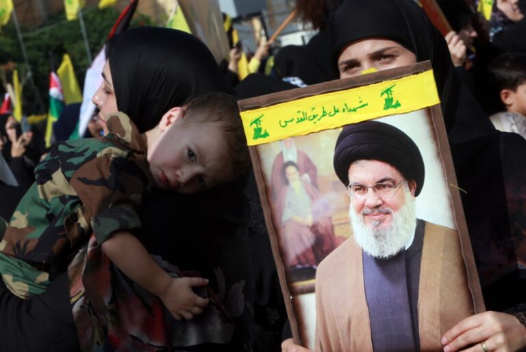Hezbollah supporters hold a picture of Hezbollah Secretary General Sayyed Hassan Nasrallah on November 3rd 2023. Photo: Haitham al-Mousawi/Al-Akhbar.
