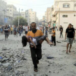 Calling Israel’s bombing of Palestinian civilians an act of ‘self-defence’ is a disingenuous labelling of Israel’s actions: a Palestinian man carries a wounded girl at the site of Israeli strikes, in Khan Younis in the southern Gaza Strip, October 14, 2023. Photo: Reuters.