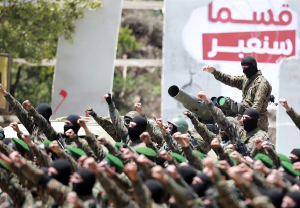 Hezbollah fighters salute at a parade. Photo: Al-Akbar/Haitham al-Mousawi