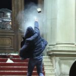 Protestors throw rocks staging a protest in front of Belgrade City Council building objecting to the result of general and local elections, in Belgrade, Serbia on December 24, 2023. Photo: Filip Stevanovic/Anadolu via Getty Images.