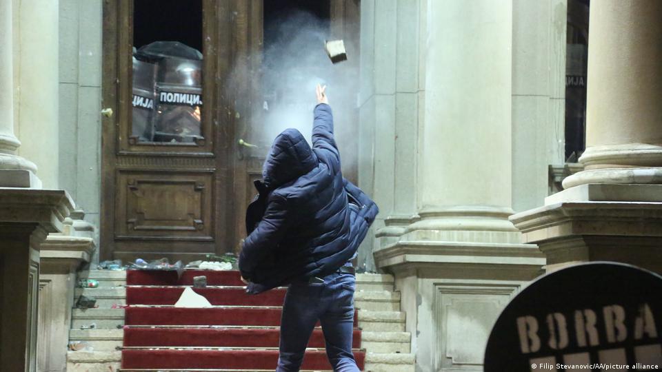 Protestors throw rocks staging a protest in front of Belgrade City Council building objecting to the result of general and local elections, in Belgrade, Serbia on December 24, 2023. Photo: Filip Stevanovic/Anadolu via Getty Images.