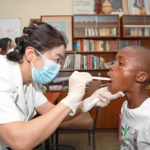 A member of a Chinese medical team examines a child at the SOS Children's Village in Windhoek, Namibia, December 11, 2023. Photo: Xinhua.