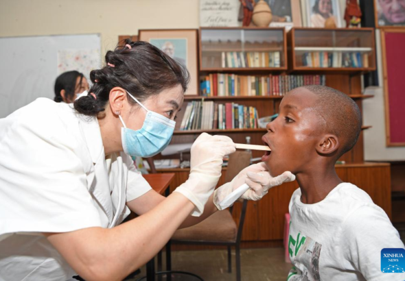 A member of a Chinese medical team examines a child at the SOS Children's Village in Windhoek, Namibia, December 11, 2023. Photo: Xinhua.