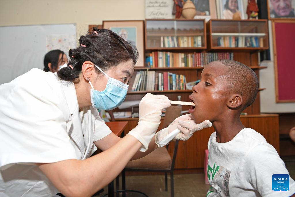 A member of a Chinese medical team examines a child at the SOS Children's Village in Windhoek, Namibia, December 11, 2023. Photo: Xinhua.