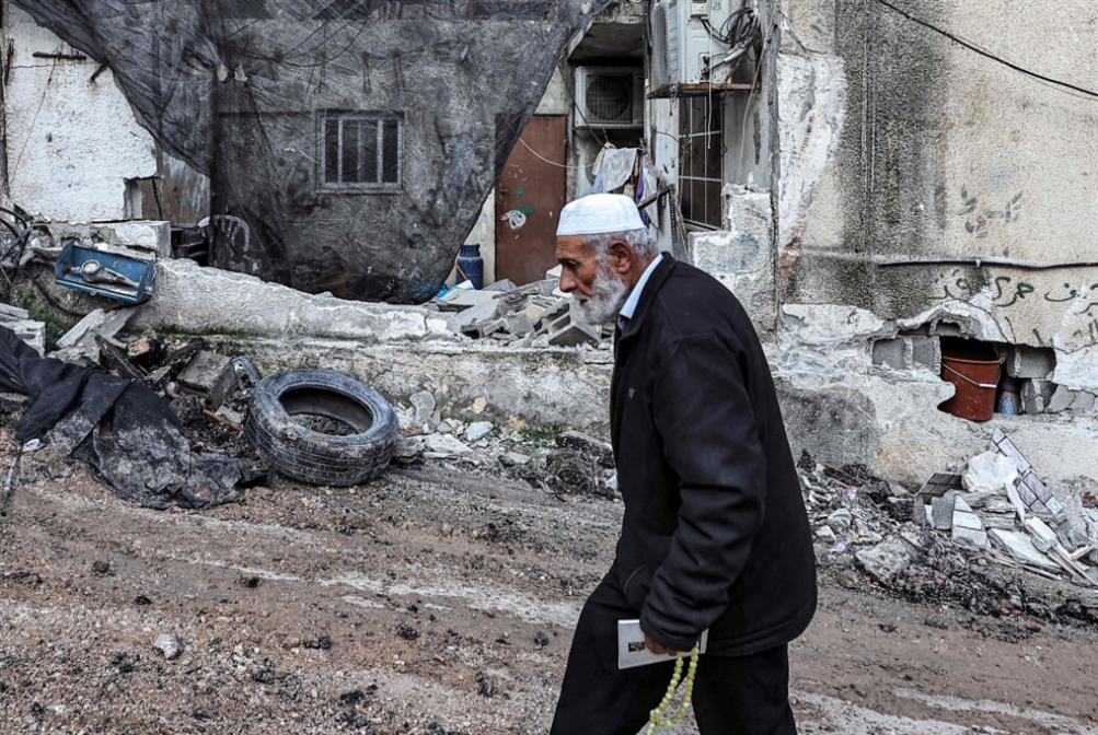 An elderly Palestinian man walks through the destroyed Al Maghazi refugee camp in central Gaza, December 2023. Photo: Middle East Eye.