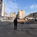 Journalist Yousef Fares stands in front of a destroyed city block in Northern Gaza on December 28, 2023. Photo: Yousef Fares Telegram.