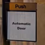 'Push: Automatic Door.' reads a sign. Photo: Substack.