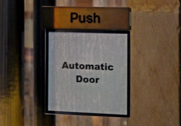 'Push: Automatic Door.' reads a sign. Photo: Substack.