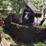 Two Hezbollah fighters stand near Katyusha rockets in the southern village of Ein Qana, Lebanon. Photo: AP/Mohammed Zaatari.