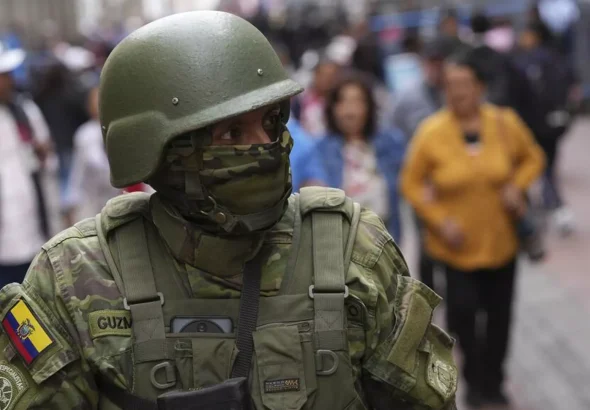 Featured image: Ecuadorian soldier on a crowded street. Photo: Dolores Ochoa/AP.