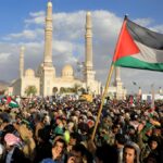 Demonstrators, one holding a Palestinian flag, rally in solidarity with Palestine in front of Masjid Al-Saleh Mosque in Sana’a, Yemen on January 5, 2024. Photo: AFP.