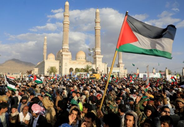 Demonstrators, one holding a Palestinian flag, rally in solidarity with Palestine in front of Masjid Al-Saleh Mosque in Sana’a, Yemen on January 5, 2024. Photo: AFP.
