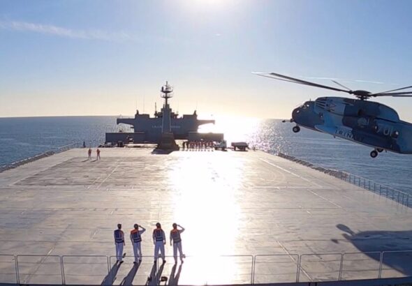 This image made from a video released Jan. 13, 2021, by the Iranian Army shows a helicopter landing on the Makran logistics vessel during a navy drill. Photo: PressTV.