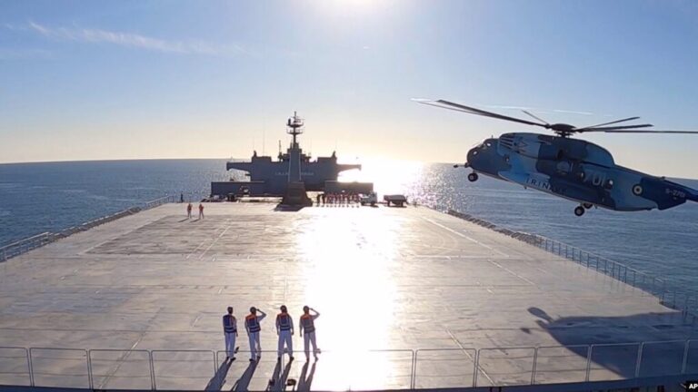 This image made from a video released Jan. 13, 2021, by the Iranian Army shows a helicopter landing on the Makran logistics vessel during a navy drill. Photo: PressTV.