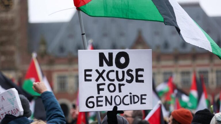 Pro-Palestinian protesters gather near the International Court of Justice (ICJ) carrying Palestinian flags and a poster reading “No Excuse for Genocide.” Photo: CBC.