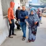 A woman injured in Israeli airstrike being escorted to the Kamal Adwan hospital, northern Gaza, December 2023. Photo: Social media.