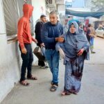 A woman injured in Israeli airstrike being escorted to the Kamal Adwan hospital, northern Gaza, December 2023. Photo: Social media.
