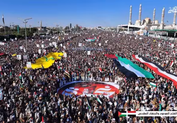 Millions of people rally in Sana'a Yemen on January 12th, 2024 against the US/UK aggression and in solidarity with Palestine. Very large flags of Yemen, Palestine, and Hezbollah can be seen. Photo: Ansarallah Military Media Telegram.