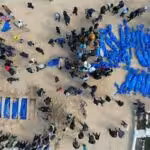 Palestinians victims of Israeli genocide being buried in blue bags. Photo: The Palestine Information Center.