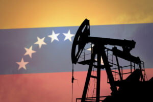 Photo collage composition displaying an oil rig with a Venezuelan flag in the background. Photo: Anton Watman/Shutterstock.