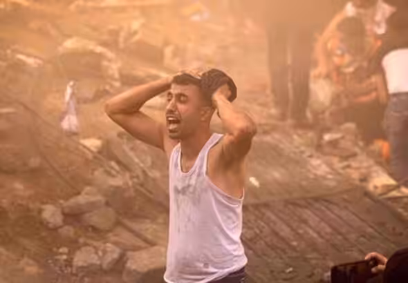 A Palestinian man looks devastated after a building in Khan Yunis in Gaza was demolished by an Israeli airstrike on 6 November, 2023. Photo: AFP.