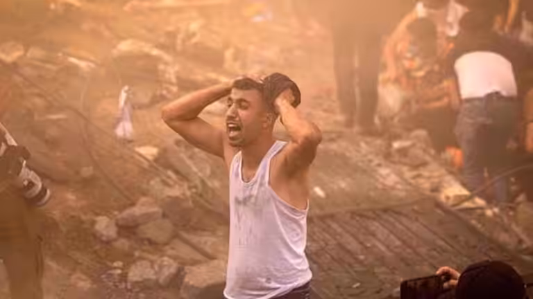 A Palestinian man looks devastated after a building in Khan Yunis in Gaza was demolished by an Israeli airstrike on 6 November, 2023. Photo: AFP.