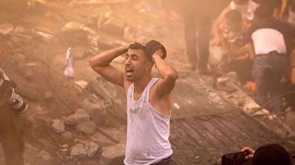A Palestinian man looks devastated after a building in Khan Yunis in Gaza was demolished by an Israeli airstrike on 6 November, 2023. Photo: AFP.