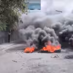 A burning tire barricade in Port-au-Prince on Feb. 6, the second of three days of intense protests which were unsuccessful in forcing de facto Prime Minister Ariel Henry from power. Photo: Haïti Liberté.