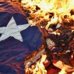 US flag on fire. Photo: Timothy D. Easley/Courier Journal.