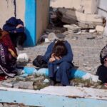 Palestinians rest next to damaged buildings after arriving in Rafah after they were evacuated from Nasser Hospital in Khan Younis in the southern Gaza Strip on February 4, 2024. Photo: Reuters.